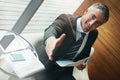 Nice to meet you. Please have a seat. Portrait of a mature businessman extending his arm to shake hands in an office. Royalty Free Stock Photo