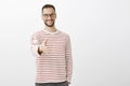 Nice to meet you. Portrait of friendly confident adult businessman in striped pullover, pulling hand towards camera in Royalty Free Stock Photo