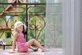 Nice toddler girl in sunhat on balcony Royalty Free Stock Photo