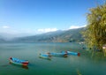 Nice tourist boats of Lake Pheva, mountains and clouds Royalty Free Stock Photo