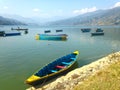 Nice tourist boats of Lake Pheva, mountains and clouds Royalty Free Stock Photo