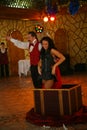 Nice trick - an impressive magician and his beautiful brunette assistant, bright stunt on stage.