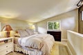 Nice upstairs bedroom with king size bed and vaulted ceiling. Royalty Free Stock Photo