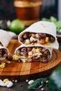 Nice vegetarian burrito over black table on wooden board. Royalty Free Stock Photo