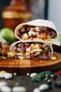 Nice vegetarian burrito over black table on wooden board. Royalty Free Stock Photo