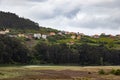 Nice view of houses on a hill next to the sea full of trees in Galicia, Spain