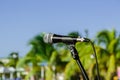 Nice view of microphone on stand in outdoor tropical garden against blue sky background Royalty Free Stock Photo