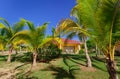 Nice view of resort bungalow house standing in tropical garden against blue sky background