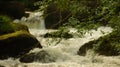 A nice view of a stream flowing between rocks forming small waterfalls Royalty Free Stock Photo