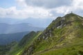 Mountain Pip Ivan in the cloudy day is opened from the green valley covered with bushes and pathway. Carpathians Royalty Free Stock Photo