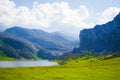 Nice views of Ercina Lake in Covadonga, Asturias, Spain. Green grassland with a glaciar lake and mountains at the background Royalty Free Stock Photo