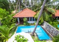 Nice villa at tropical hotel. Idyllic scenic backyard with swimming pool Royalty Free Stock Photo