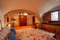 Nice warm interior of bedroom in a rustic style in country house or hotel. Wooden beams and walls made of natural stone. Royalty Free Stock Photo