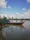 Nice weather, boat parked at the riverside