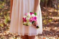 Bride in pink holding a bridal bouquet of flowers