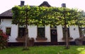 White rural house with a small garden