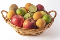 Nice wicker basket full of fresh and varied fruit, on a white background Royalty Free Stock Photo