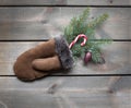 nice winter time view with gloves and candy cane on wooden background Royalty Free Stock Photo