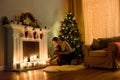 Woman in a lighted christmas room fixing candles Royalty Free Stock Photo