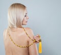 Nice woman with fashion jewellery accessories long necklace. Female back. Blonde model lady Royalty Free Stock Photo