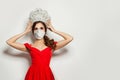 Nice woman fashion model wearing medical face mask and diamond crown