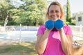 Nice woman holds dumbbells during her fitness sessions at home