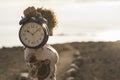 Nice woman take a big clock alarm old one and vintage on hand showing you the minutes and secods. rush and timeless concept. Royalty Free Stock Photo