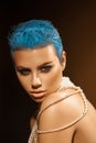 Nice young adult woman with short blue hairstyle and pearls on n Royalty Free Stock Photo