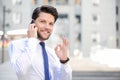 Nice young businessman holding mobile phone Royalty Free Stock Photo