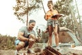 Nice young couple grilling food together on fire Royalty Free Stock Photo