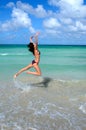 Nice young girl is jumping close to ocean Royalty Free Stock Photo