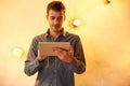 Nice young man texting on tablet Royalty Free Stock Photo