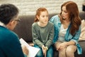 Nice young woman looking at her daughter