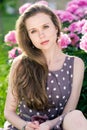 Nice young woman in the park near peonis Royalty Free Stock Photo