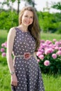 Nice young woman in the park near peonis Royalty Free Stock Photo