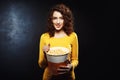 Nice young woman playing on camera with popcorn looking straight Royalty Free Stock Photo