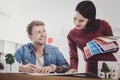 Nice young woman standing near her colleague Royalty Free Stock Photo