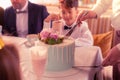 Birthday boy looking at waiter cutting nice yummy cake