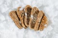 Nicely arranged frozen grey bread slices in a grinded ice. top view.