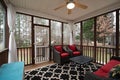 A nicely decorated screened in porch.