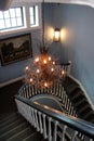 Winding staircase with elaborate lighting fixture overhead, historic Colgate Inn, Hamilton, New York, 2019