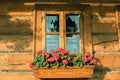 Nicely decorated window of a log cabin house. Royalty Free Stock Photo
