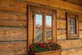 Nicely decorated window of a log cabin house. Royalty Free Stock Photo