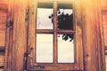 Nicely decorated window of a log cabin house. Royalty Free Stock Photo