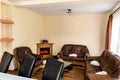 Nicely furnished sitting room with brown sofas and a glass table inside of a modern house