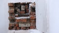 A niche in a white wall with bricks