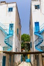 NICOSIA, CYPRUS - MAY 30, 2014 : View on the narrow street and white houses with blue iron helical stairs`.