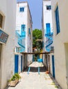 NICOSIA, CYPRUS - MAY 30, 2014 : View on the narrow street and white houses with blue iron helical stairs`.