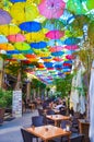 Nicosia, Cyprus - Oct 4th 2018: Outdoor restaurant garden with colorful umbrellas decorating the top of the street Royalty Free Stock Photo