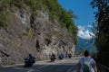 Niederhorn, Switzerland - August 12, 2019 - a group of motorcyclists riding down the street at the foot of the mountains